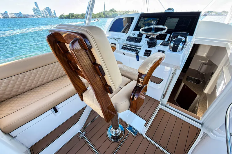 Slide: The Image of Luxurious 2016 SeaVee 430 yacht interior with elegant helm and seating, overlooking scenic waterfront. - 29