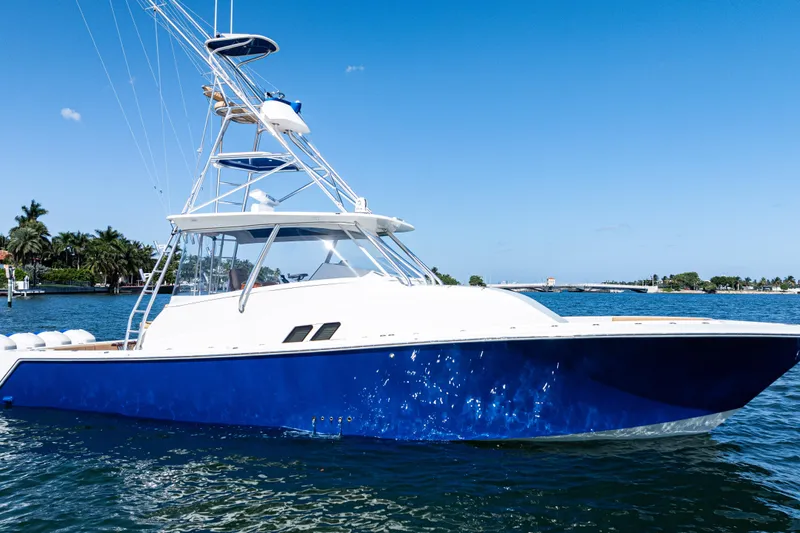 Slide: The Image of 2016 SeaVee 430 boat with four Mercury engines on a sunny day, city skyline in background. - 3