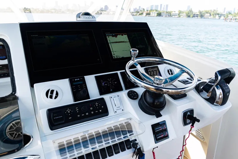 Slide: The Image of 2016 SeaVee 430 boat helm with advanced navigation controls and steering wheel. - 32