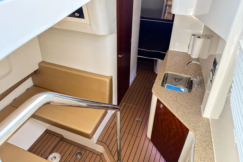 Slide: The Image of Interior of 2016 SeaVee 430 boat with seating, kitchenette, and wood flooring. - 36