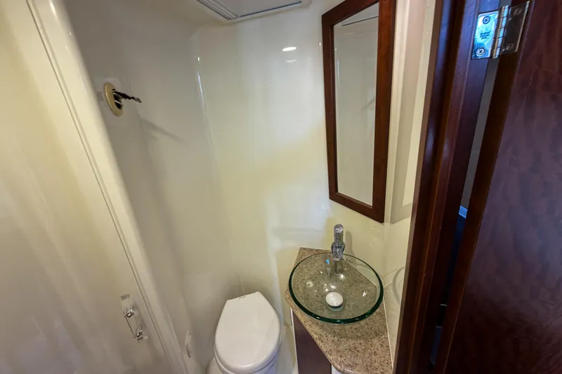 Slide: The Image of Compact bathroom in 2016 SeaVee 430 boat with modern sink and toilet. - 41