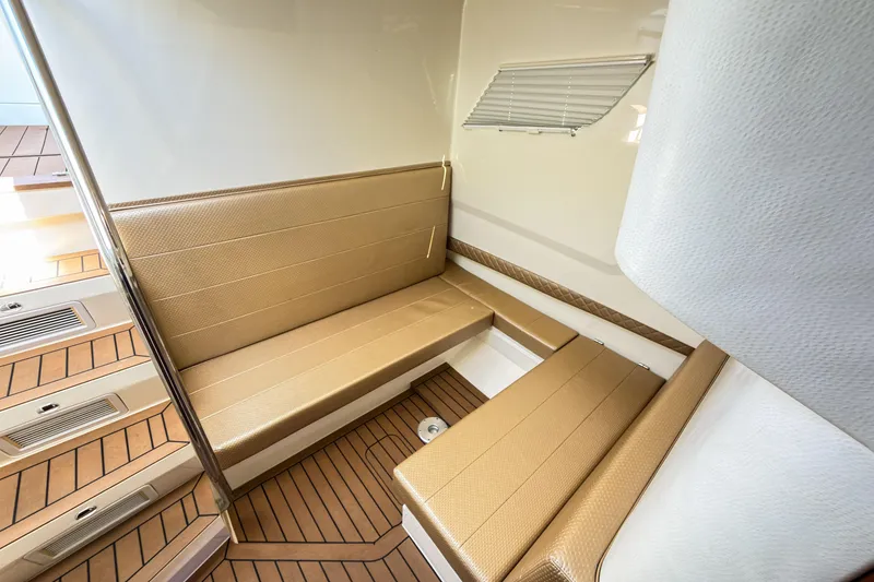 Slide: The Image of 2016 SeaVee 430 interior with tan seating and wood-patterned flooring. - 43