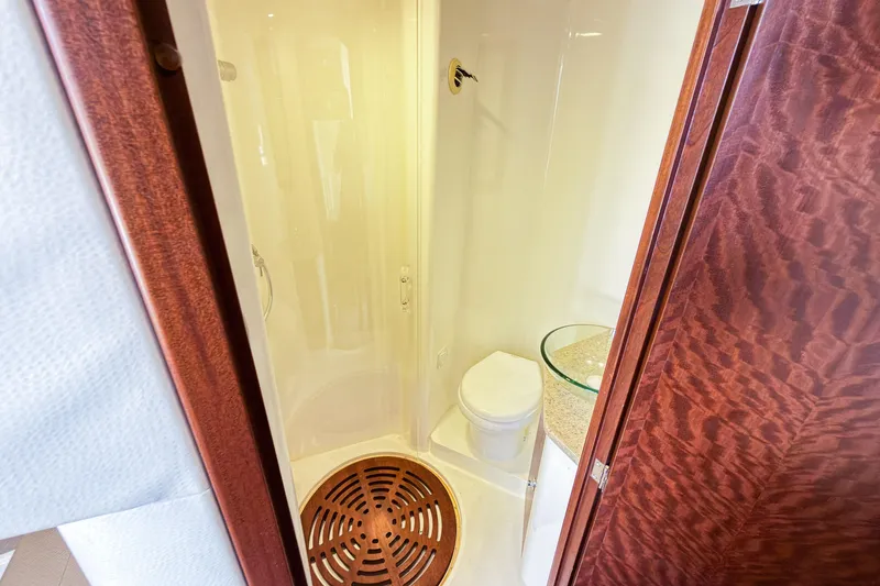 Slide: The Image of Luxurious 2016 SeaVee 430 yacht bathroom with shower, toilet, and glass sink. - 45