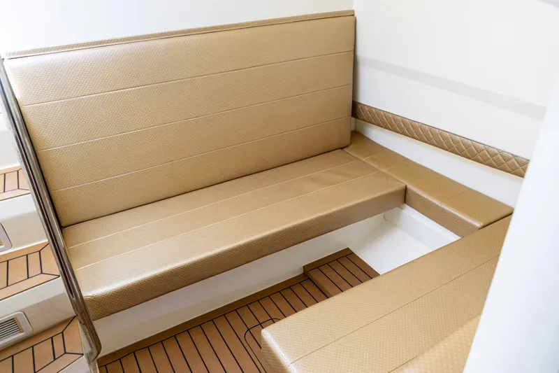Slide: The Image of Luxurious seating area on 2016 SeaVee 430 boat with tan upholstery and wood flooring. - 46
