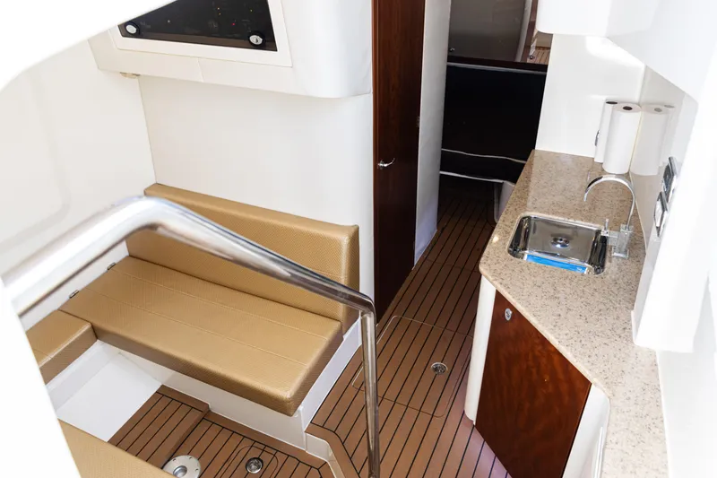 Slide: The Image of Interior of 2016 SeaVee 430 boat with seating, kitchenette, and wood flooring. - 47