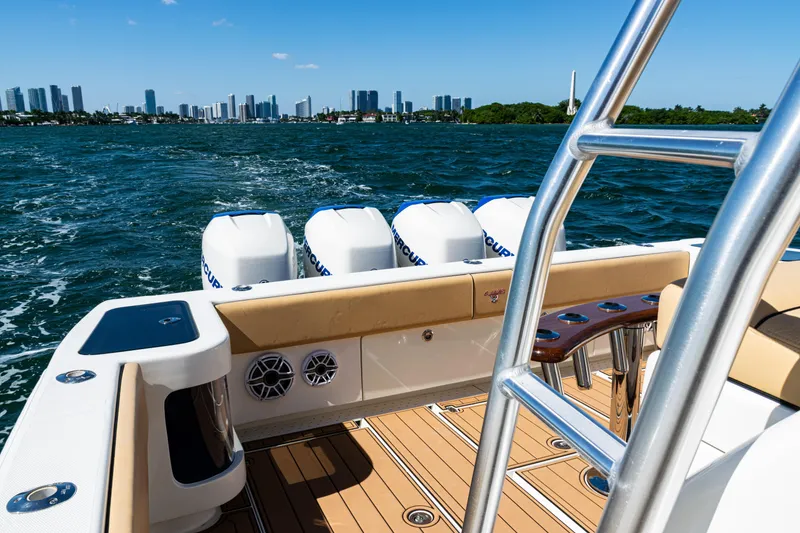 Slide: The Image of 2016 SeaVee 430 boat with multiple engines cruising near city skyline. - 48