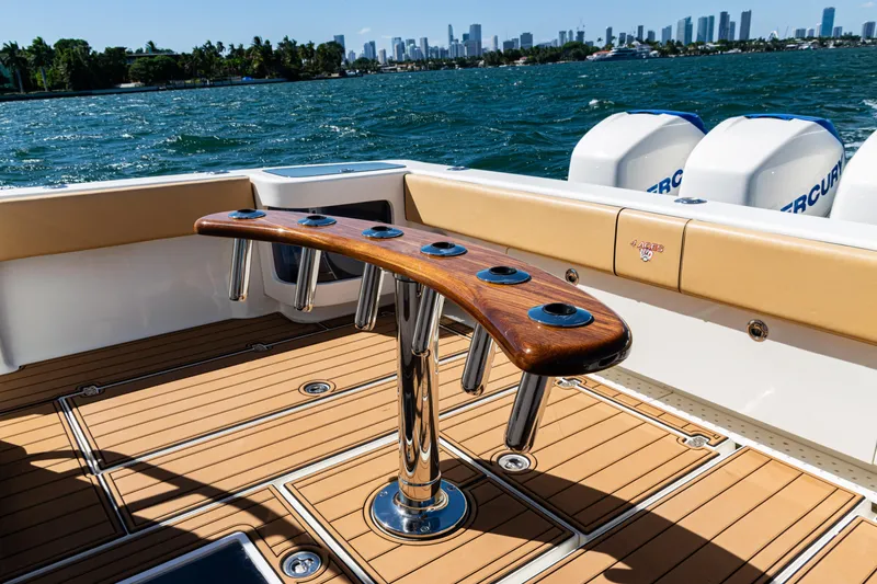 Slide: The Image of 2016 SeaVee 430 boat deck with rod holders, overlooking city skyline and water. - 50