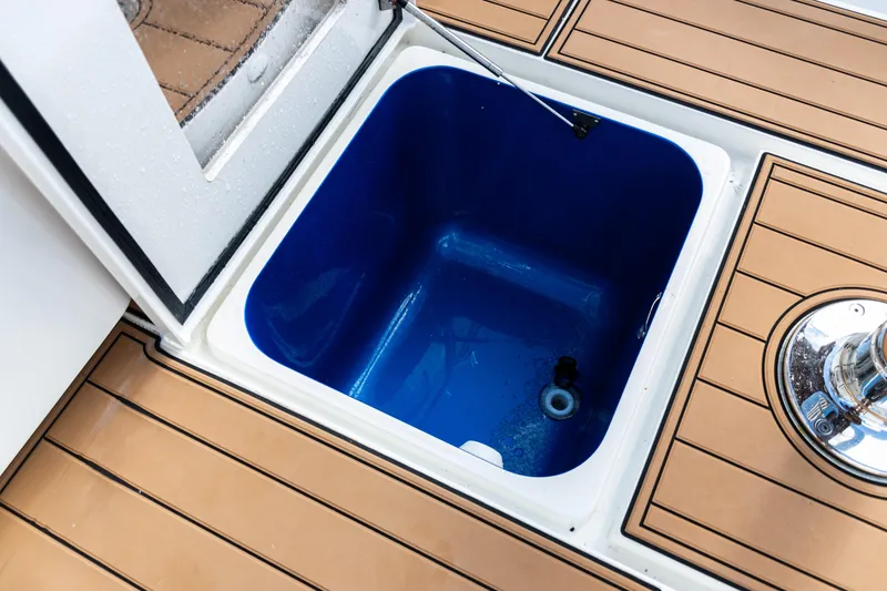 Slide: The Image of Open storage compartment on 2016 SeaVee 430 boat with teak flooring. - 57