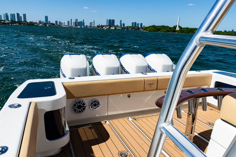 Slide: The Image of 2016 SeaVee 430 boat with four engines, cruising on a sunny day near a city skyline. - 59