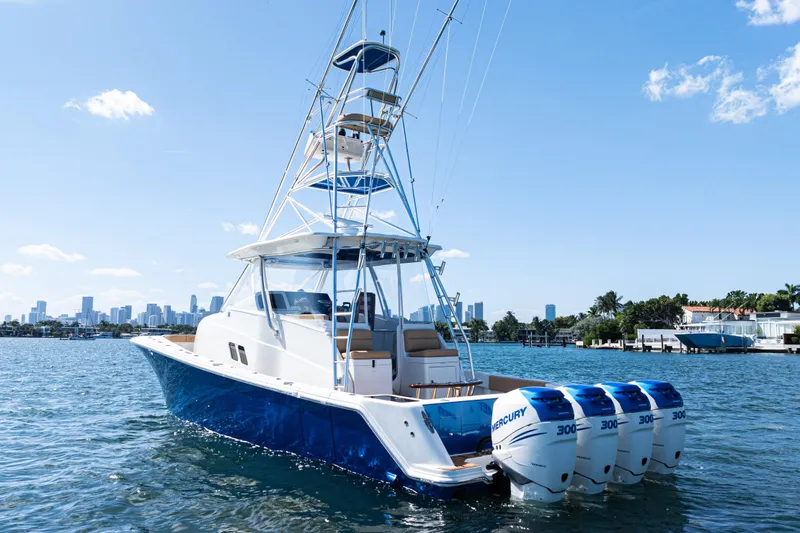 Slide: The Image of 2016 SeaVee 430 boat on water, clear sky, luxury waterfront homes in background. - 6