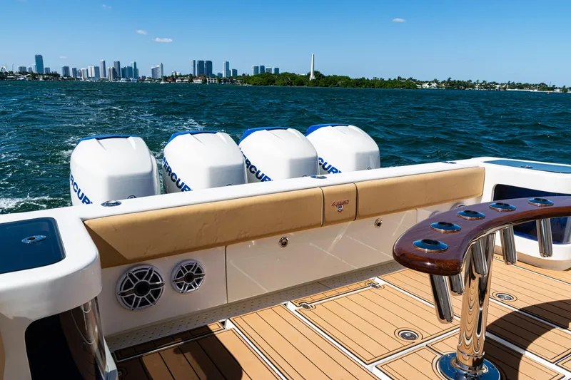Slide: The Image of 2016 SeaVee 430 boat with four outboard engines, cruising on a sunny day. - 60