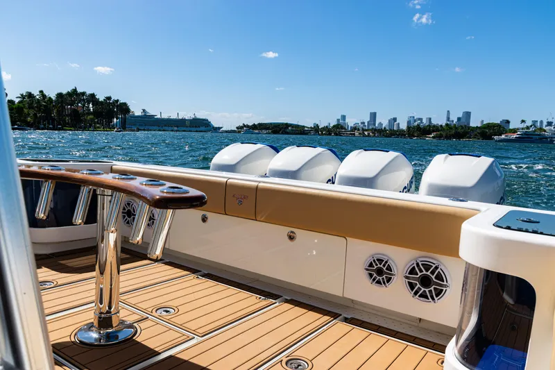 Slide: The Image of 2016 SeaVee 430 boat with powerful engines, cruising near a city skyline on a sunny day. - 64