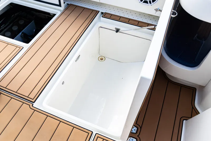Slide: The Image of 2016 SeaVee 430 boat deck with open storage compartment and teak flooring. - 67