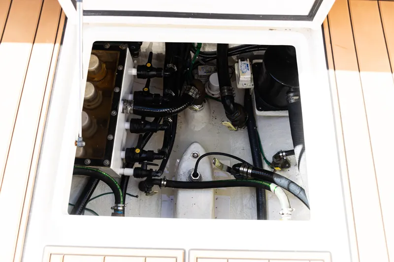 Slide: The Image of Engine compartment of 2016 SeaVee 430 boat, showcasing hoses and mechanical components. - 68