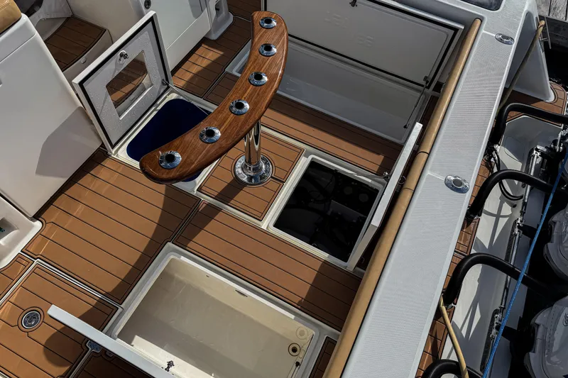 Slide: The Image of 2016 SeaVee 430 boat deck with rod holders and storage compartments. - 69