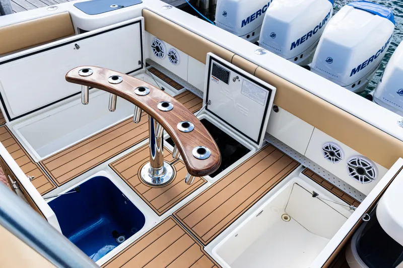 Slide: The Image of 2016 SeaVee 430 boat deck with rod holders, storage, and Mercury engines. - 70