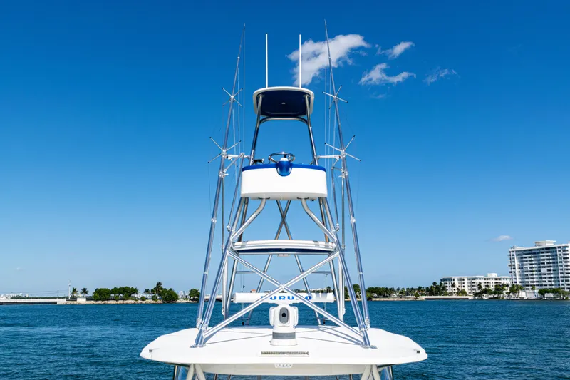 Slide: The Image of 2016 SeaVee 430 boat with tower against clear blue sky and waterfront buildings. - 77