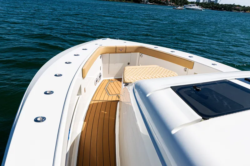 Slide: The Image of 2016 SeaVee 430 boat deck with cushioned seating on calm water. - 8