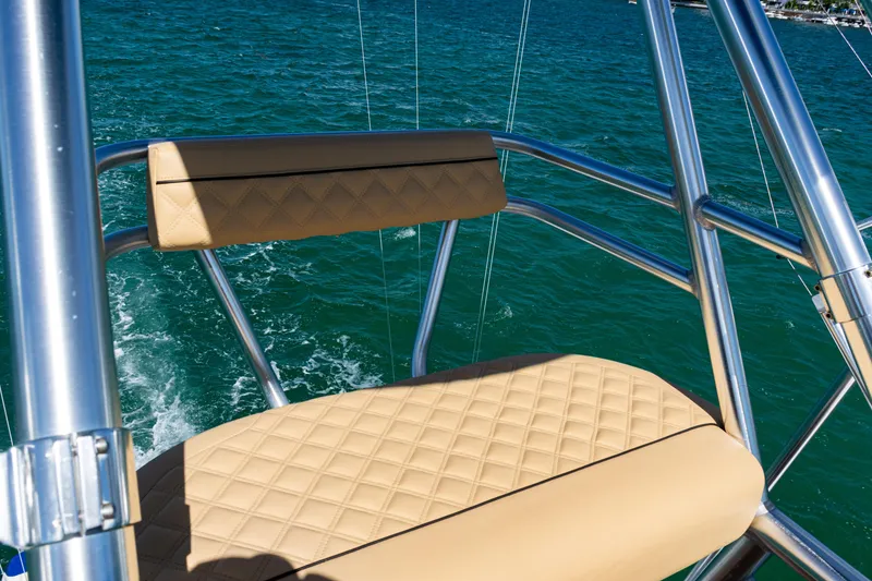 Slide: The Image of 2016 SeaVee 430 boat with tan cushioned seating and stainless steel frame on open water. - 83