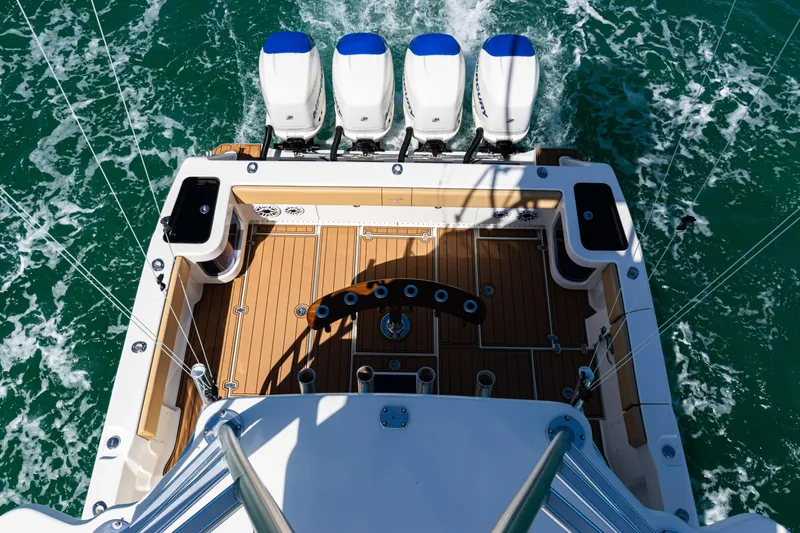 Slide: The Image of 2016 SeaVee 430 boat with four engines, teak deck, and fishing setup on open water. - 84