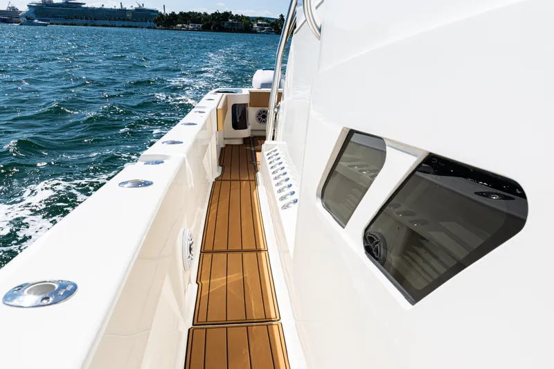 Slide: The Image of 2016 SeaVee 430 boat with teak deck, cruising on open water. - 92