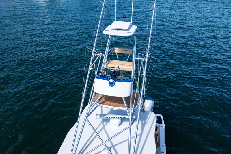 Slide: The Image of 2016 SeaVee 430 boat on water, featuring a tower and fishing equipment. - 98