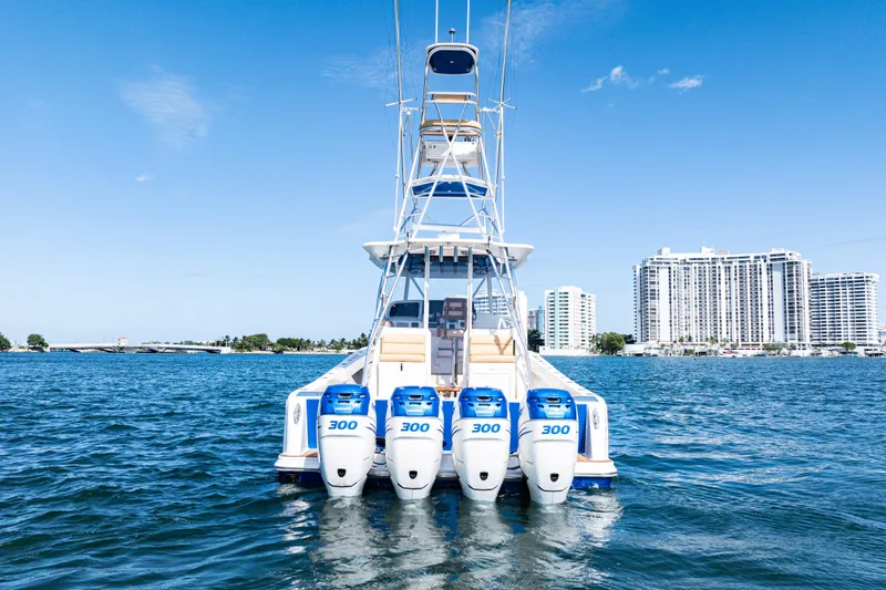 Slide: The Image of 2016 SeaVee 430 boat with four 300 horsepower engines on water, cityscape background. - 99