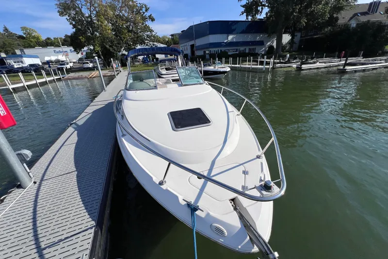 Slide: The Image of 1996 Chaparral 196 SSi boat docked at a marina on a sunny day. - 11