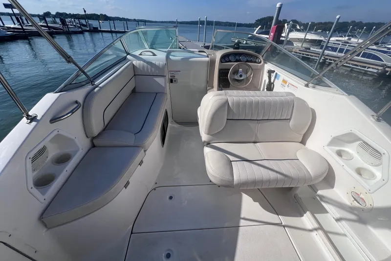 Slide: The Image of 1996 Chaparral 196 SSi boat interior with white seating, steering wheel, and cup holders. - 15