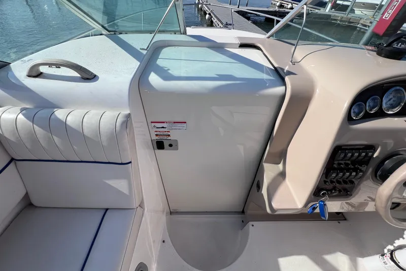 Slide: The Image of 1996 Chaparral 196 SSi boat interior with dashboard and seating, dockside view. - 19