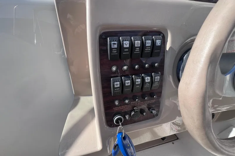 Slide: The Image of Control panel of a 1996 Chaparral 196 SSi boat with various switches and key. - 21