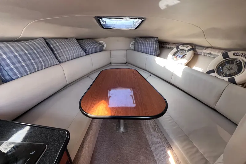 Slide: The Image of Interior of 1996 Chaparral 196 SSi boat with cozy seating and wooden table. - 25
