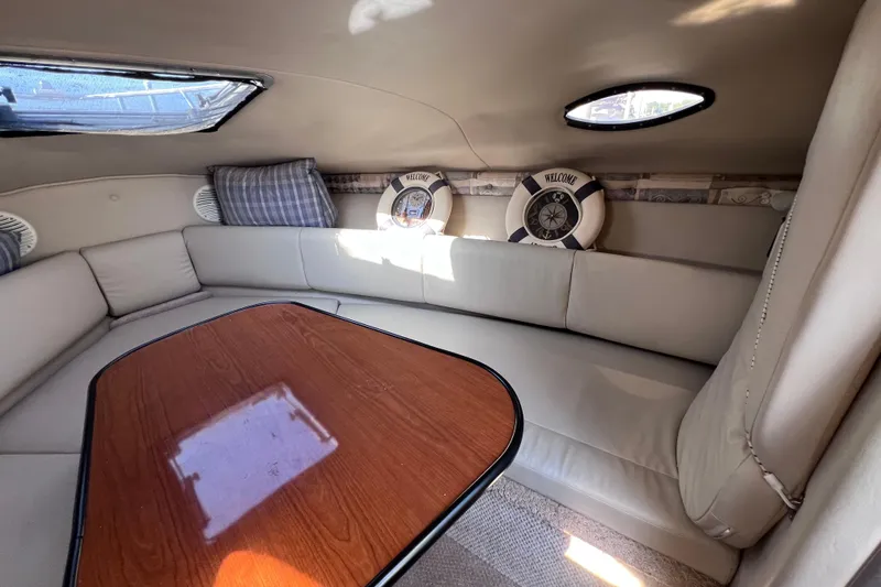 Slide: The Image of Interior of 1996 Chaparral 196 SSi boat with cozy seating and wooden table. - 26