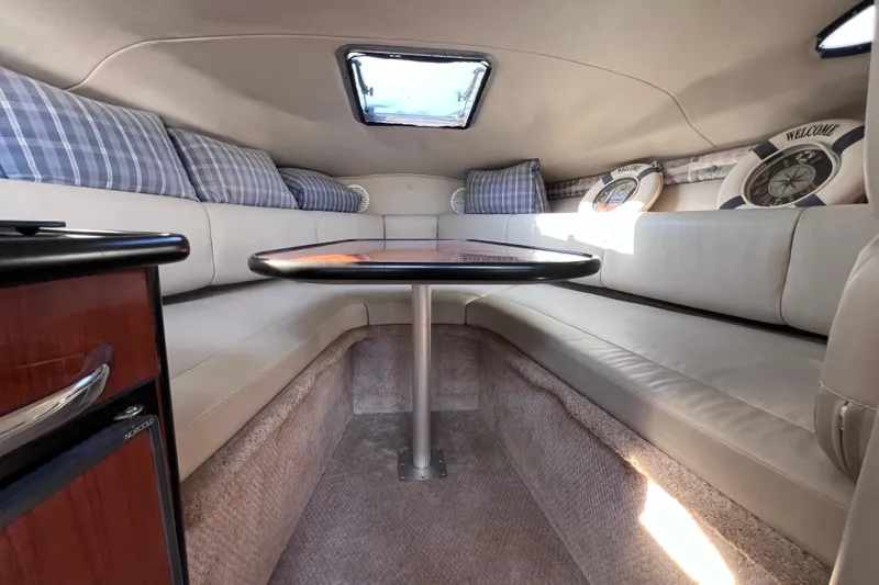 Slide: The Image of Interior of a 1996 Chaparral 196 SSi boat with cozy seating and table. - 28