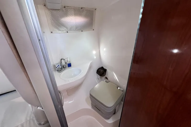 Slide: The Image of Interior of 1996 Chaparral 196 SSi boat bathroom with sink and toilet. - 29