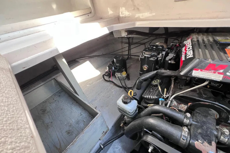 Slide: The Image of Engine compartment of a 1996 Chaparral 196 SSi boat, featuring a Mercury engine. - 35