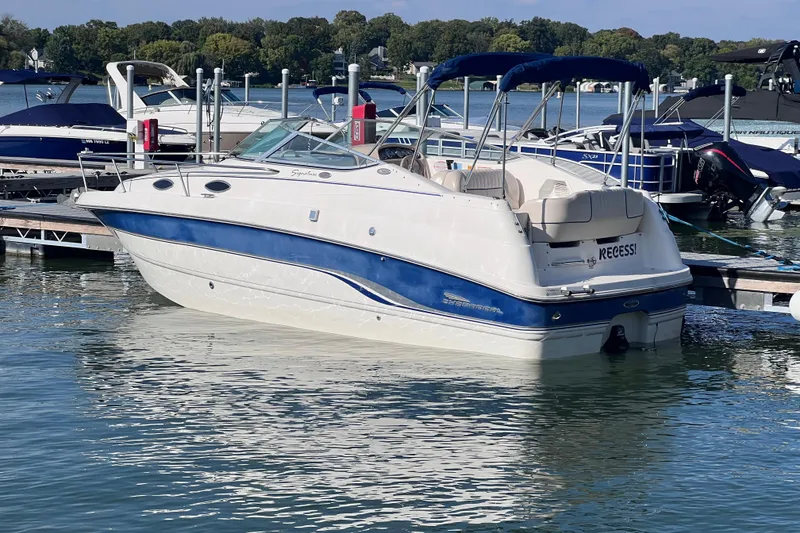 Slide: The Image of Chaparral 196 SSi 1996 boat docked on a sunny lake with blue accents. - 4