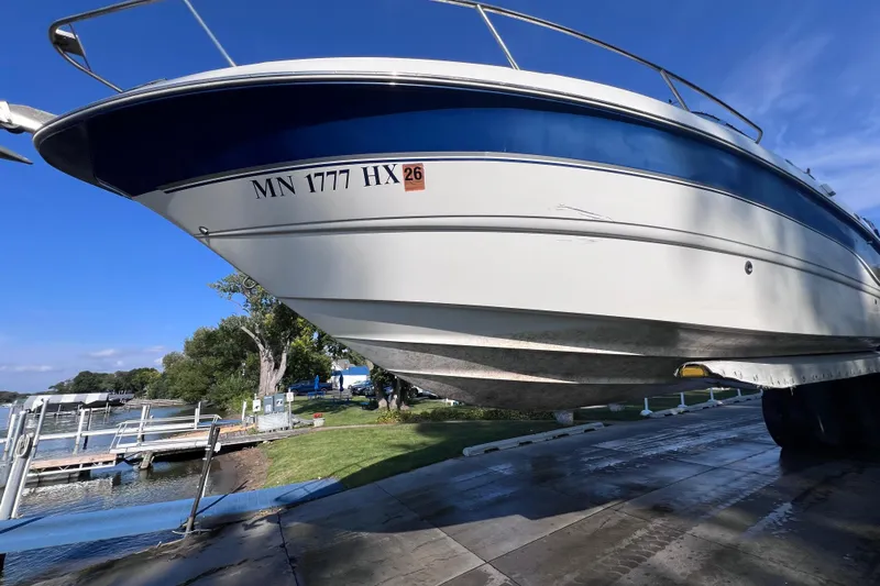 Slide: The Image of 1996 Chaparral 196 SSi boat on trailer, dockside view, clear blue sky. - 44