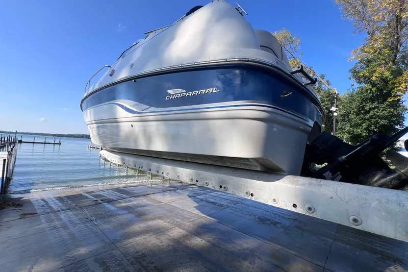 Slide: The Image of Chaparral 196 SSi boat from 1996 on a trailer by a lakeside dock. - 46