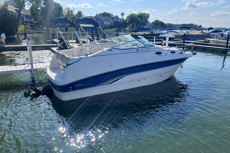 Slide: The Image of 1996 Chaparral 196 SSi boat docked on a sunny day, reflecting on calm water. - 7