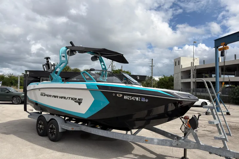 The Image of 2019 Nautique Super Air Nautique G23 Coastal Edition on trailer, parked outdoors. - 1