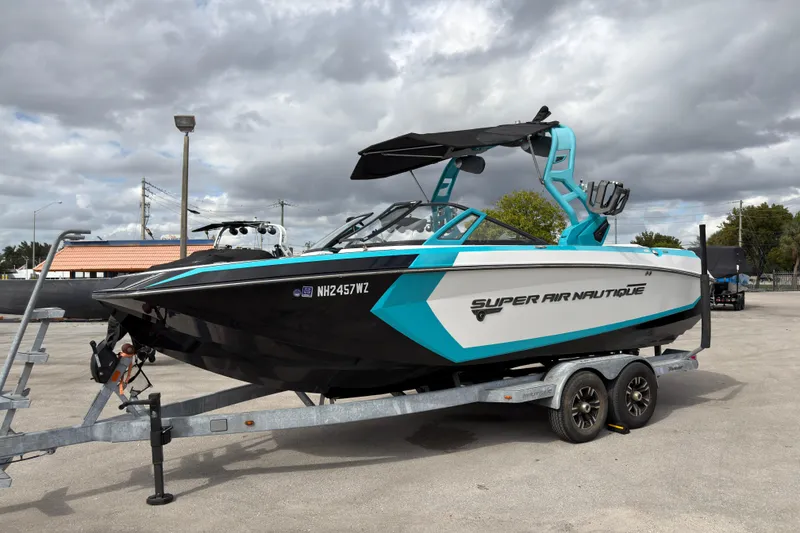 Slide: The Image of 2019 Nautique Super Air Nautique G23 Coastal Edition on trailer, under cloudy sky. - 11