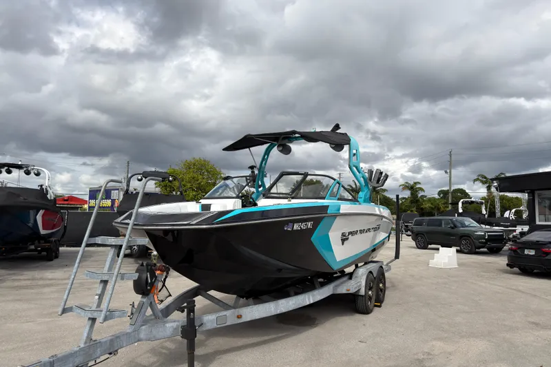 Slide: The Image of 2019 Nautique Super Air Nautique G23 Coastal Edition on trailer under cloudy sky. - 12