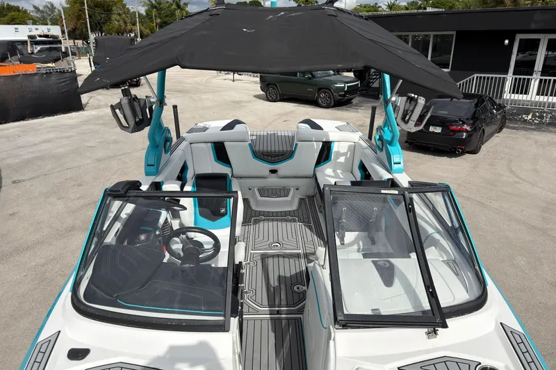 Slide: The Image of 2019 Nautique Super Air Nautique G23 Coastal Edition boat interior with seating and steering wheel. - 14