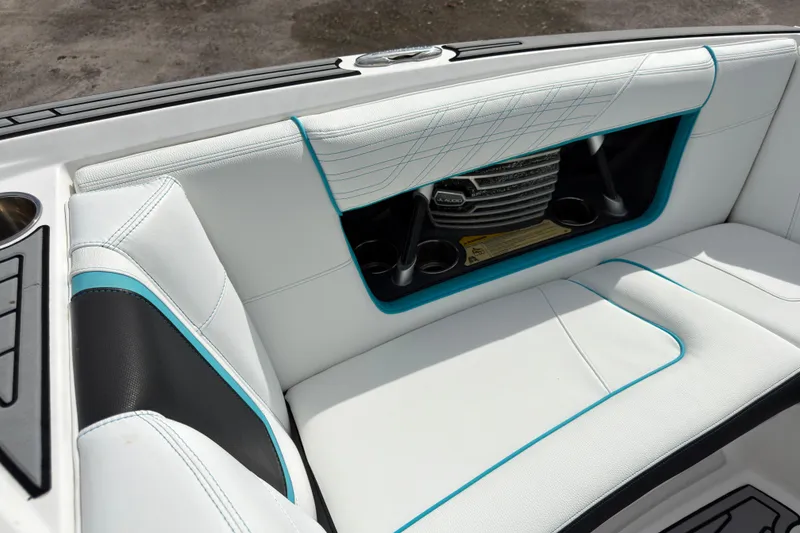 Slide: The Image of 2019 Nautique Super Air Nautique G23 Coastal Edition interior with white and teal upholstery. - 15