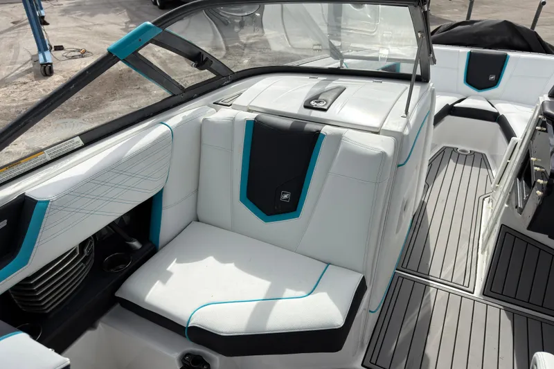 Slide: The Image of 2019 Nautique Super Air Nautique G23 Coastal Edition interior with white and teal seating. - 19