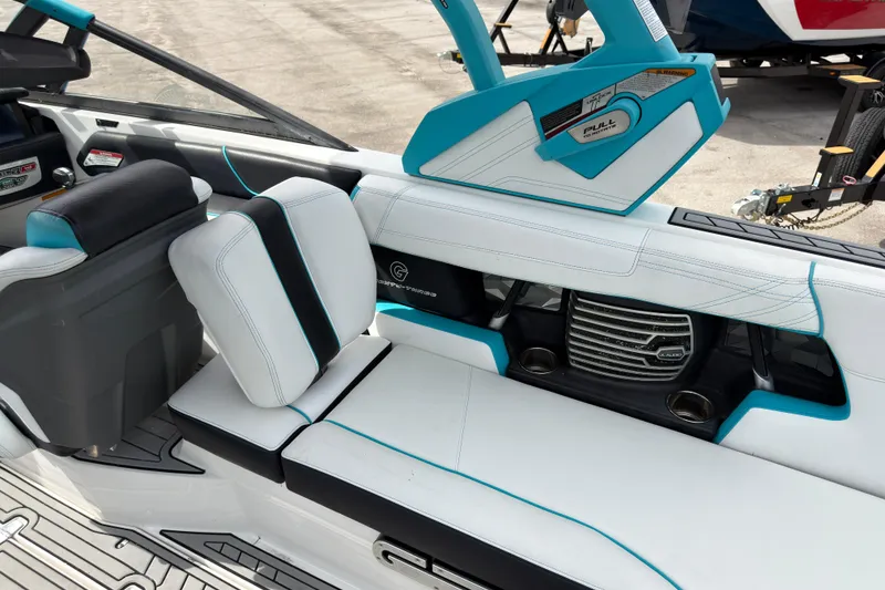 Slide: The Image of 2019 Nautique Super Air Nautique G23 Coastal Edition interior with white and blue seating. - 22
