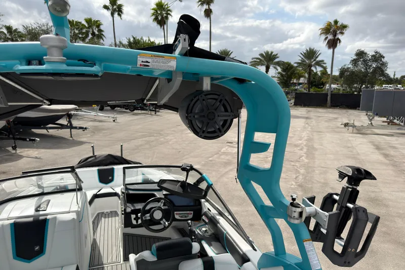 Slide: The Image of 2019 Nautique Super Air Nautique G23 Coastal Edition boat interior with blue accents and speaker system. - 23