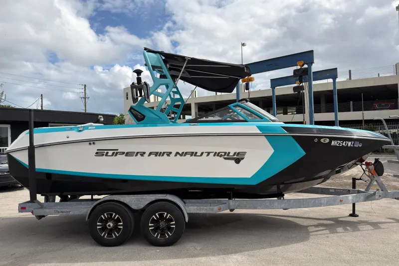 Slide: The Image of 2019 Nautique Super Air Nautique G23 Coastal Edition boat on trailer, side view. - 4