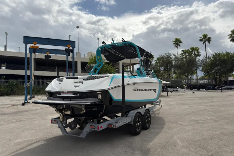 Slide: The Image of 2019 Nautique Super Air Nautique G23 Coastal Edition on trailer, parked outdoors. - 6